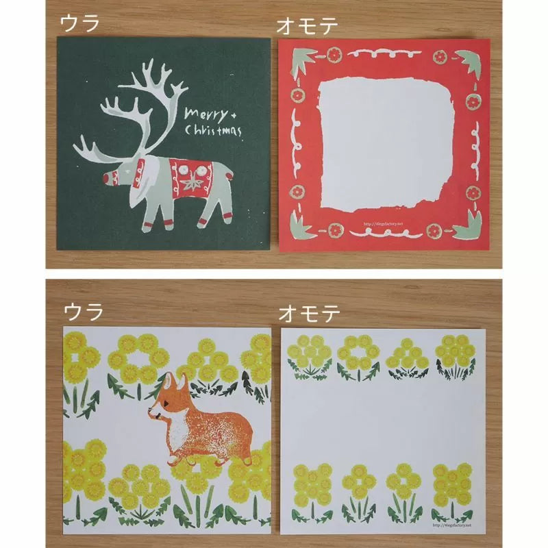 Two sets of Christmas-themed cards with reindeer and dog illustrations on a wooden surface.