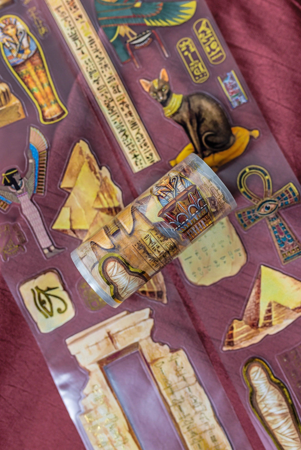 A unique extra large transparent tape design by CoraCreaCrafts. This tape features beautiful designs to transport you back in time to Ancient Egypt and the world of Pharaohs.Features: Super convenient, premium pre-cut designs, easy to peel off like stickers, beautiful gold foil detailing
Size: 10cm wide × 5m long with a 100cm repeat (that means you get 5 times 1 full meter of completely different designs!)