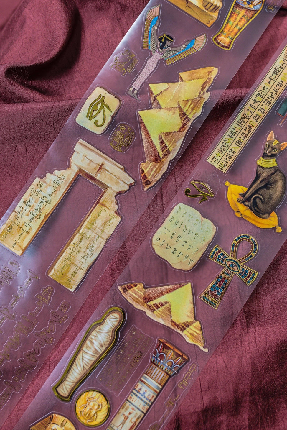 A unique extra large transparent tape design by CoraCreaCrafts. This tape features beautiful designs to transport you back in time to Ancient Egypt and the world of Pharaohs.Features: Super convenient, premium pre-cut designs, easy to peel off like stickers, beautiful gold foil detailing
Size: 10cm wide × 5m long with a 100cm repeat (that means you get 5 times 1 full meter of completely different designs!)