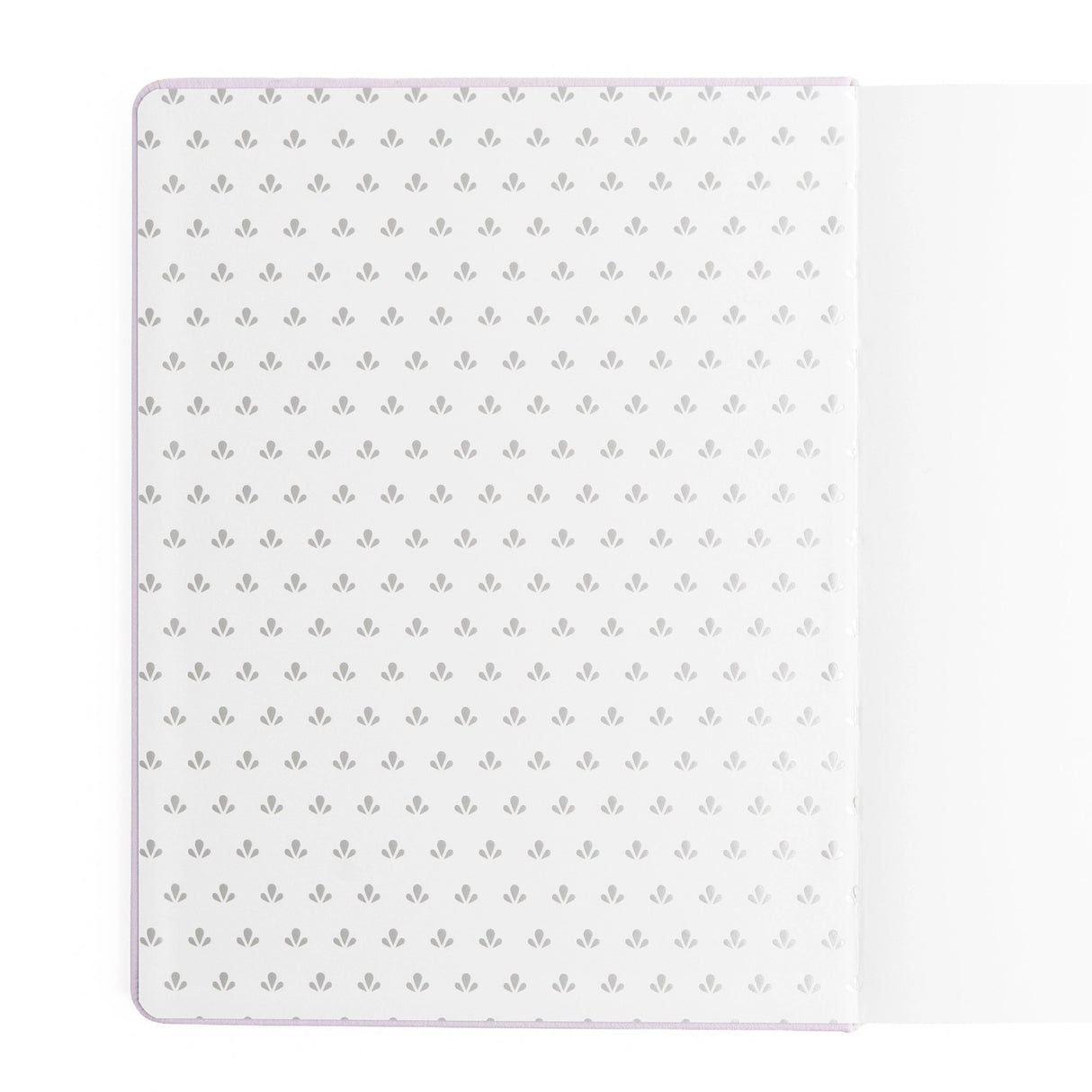 A dreamy Reading Journal in gentle lilac vegan leather, inspired by classic library bindings. Subtle geometric embossing frames a delicate open-book motif, creating a clean, elegant design that appeals to book lovers, writers, and everyday creatives.