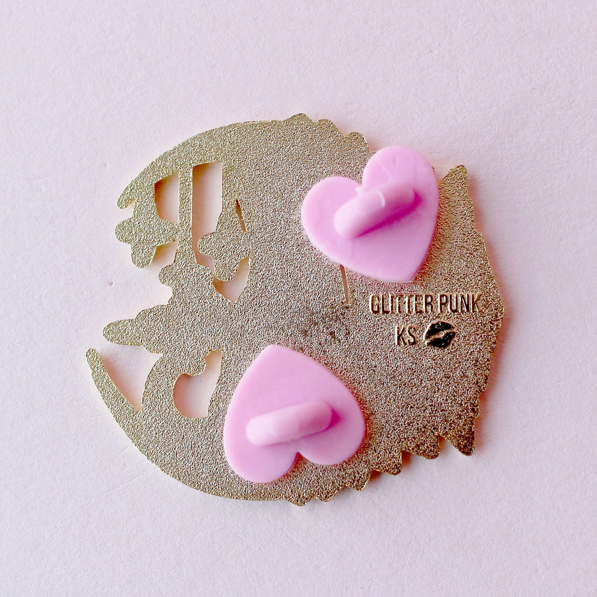 This celestial Art Deco Moon Cat is perfect for cat lovers everywhere!
It features a black cat standing on a moon filled with purple art deco shapes, with falling stars in the background.
The pin is secured by two purple heart backs and comes on a special ‘Art Deco’ Glitter Punk backing card, making it perfect for a gift or to keep as a special treat for yourself.
This pin is part of my Art Deco Cats collection – 8 enamel pins based on the fabulous 20th century visual arts movement.
Measurements: 45mm