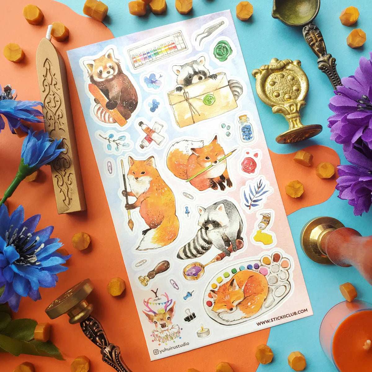 @yuhuirustudio’s woodland artists have traded the forest floor for a table full of paints, brushes, wax seals, and colorful little treasures! A fox holds its favorite brush, a red panda chooses the perfect shade, and one sleepy helper has decided a watercolor palette makes an excellent place for a nap.
Art by: @yuhuirustudio
One sticker sheet is included.
Top Coating: None
Adhesive Layer: Paper
Backing Layer: Paper
Size: 6.69"x3.54"
Weight-0.03oz