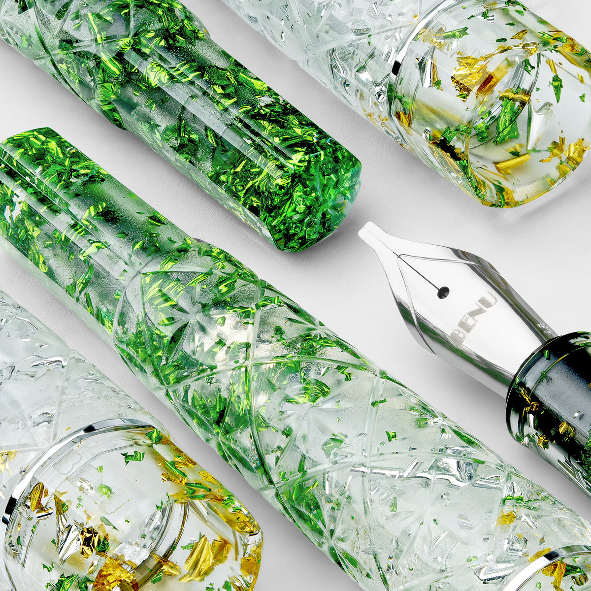 BENU Cocktail Hour Fountain Pen - Mojito
Inspired by the classic Mojito cocktail, this pen combines a transparent acrylic body with silver, green, and golden sparkling particles in a lively faceted design that beautifully interacts with light. The diamond-cut inspired surface creates depth, reflections, and movement across the material, giving the pen a fresh, glass-like appearance reminiscent of ice, lime, and sparkling summer cocktails. Bright, energetic, and refreshing, Mojito brings a playful yet sophi