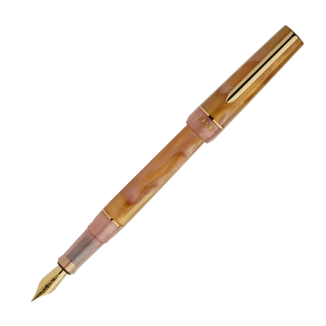 BENU presents the newest Haute Collection — a line of elegant, fashion-inspired pens that blend classic charm with bold, modern flair. The designs include both subtle and vibrant styles, showcasing BENU’s signature glitter and color artistry. Each pen features a faceted body with alternating wide and slender facets, complemented by either gold-plated or chrome-plated trims for a sleek, timeless look.
Lustre pen glows with warm swirls of amber and blush, finished in radiant gold trim.Quietly luxurious, Lust
