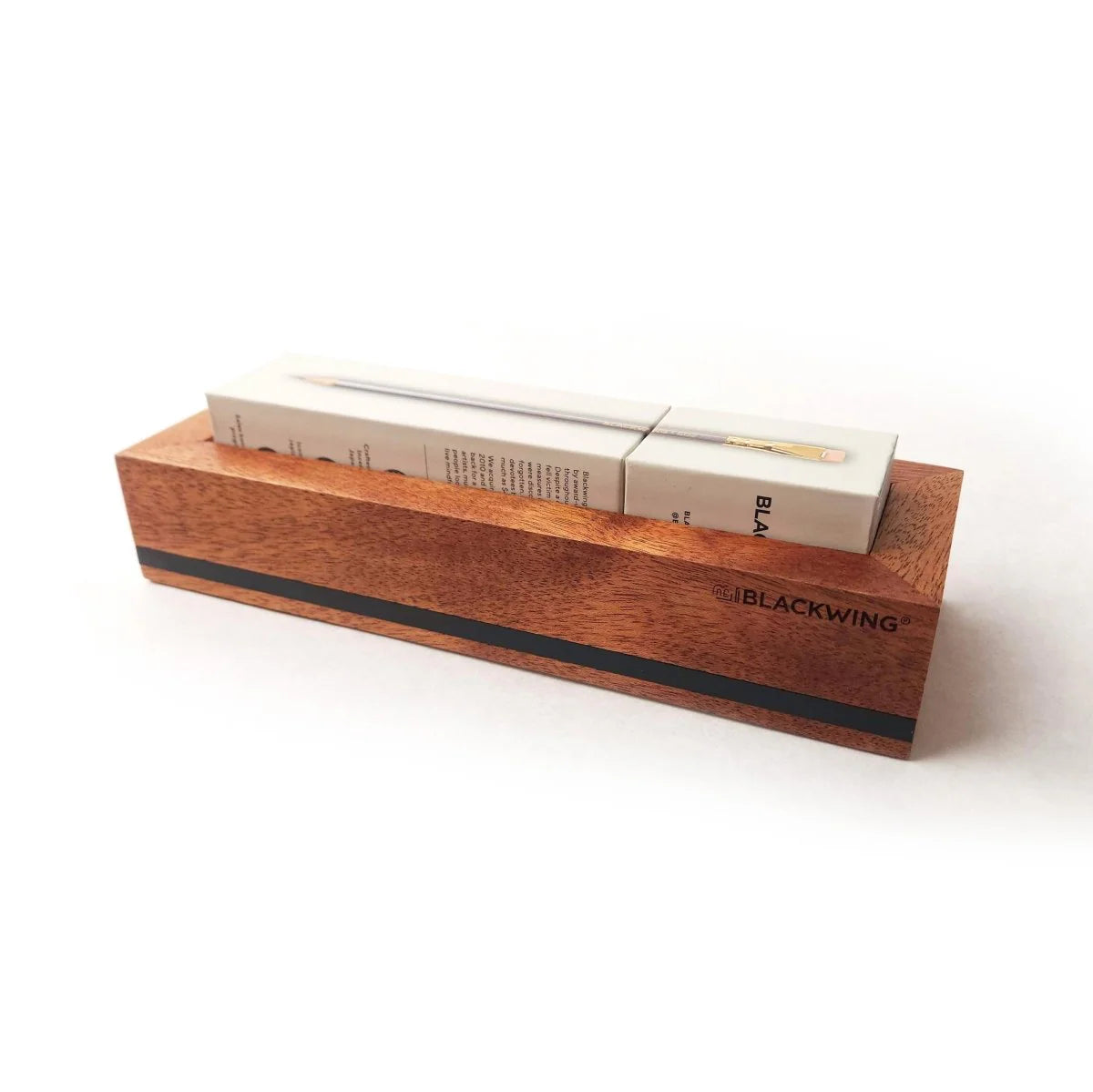 Put your favorite Blackwing 12-pack on display. This mahogany, solid wood pencil display is designed to showcase a single 12-pack Blackwing pencil box in a flat-lay position. Its clean, premium, and minimalist profile fits perfectly on every desk, shelf, or wall using the predrilled mounting holes. The Blackwing logo is engraved on the side.
The Blackwing Flat Box display measures 9.8125 x 3.25 x 1.75 inches.