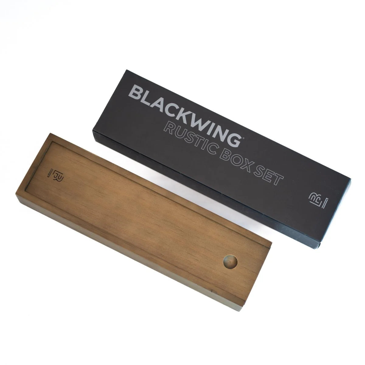 The Blackwing Rustic Box features your choice of 12 premium Blackwing graphite pencils and our reliable Two-Step Long Point Sharpener. Choose from 12 Matte pencils,12 602 pencils, 12 Pearl pencils, 12 Natural pencils, or 3 of each. The aged pine pencil box slides open to reveal the Blackwing pencils and a black cork-lined interior. The smooth stationery box is perfect for any workspace, office, or desk.