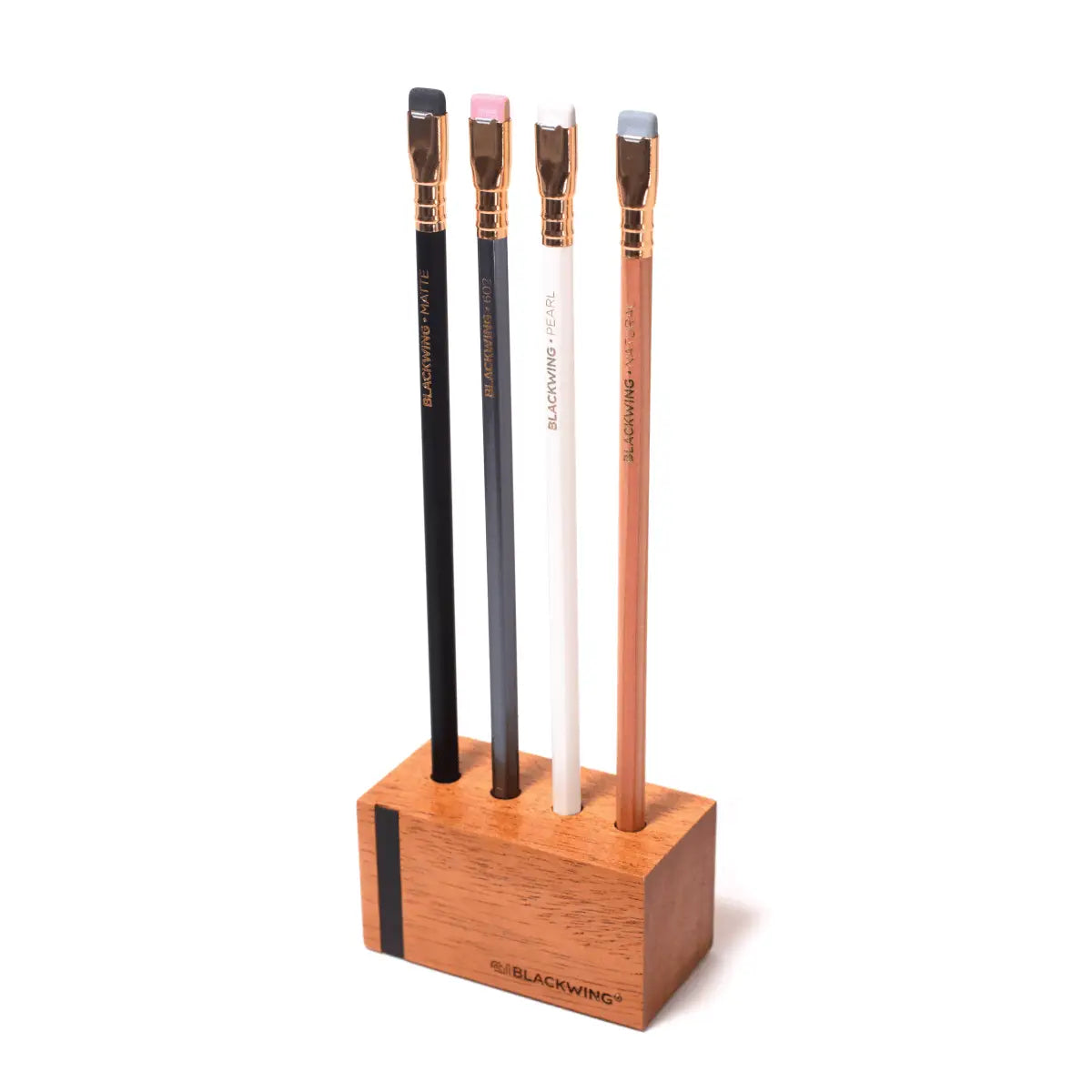 This solid wood pencil display is made with mahogany and is designed to showcase four upright Blackwing pencils. Display the four core Blackwing pencils, or choose four of your favorite designs to add some character to your desk. This display fits well on a desk or shelf, or you can hang it using the predrilled mounting holes. Blackwing logo engraved on the side.
The Blackwing Upright Four Pencil display measures 3.5 x 1.75 x 1.875 inches.