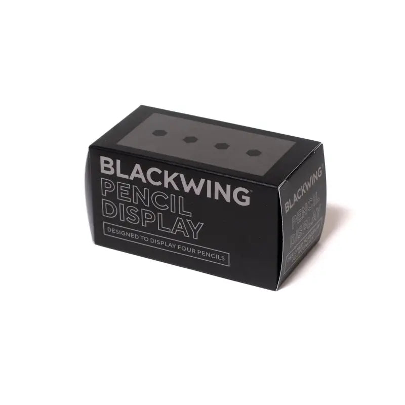 This solid wood pencil display is made with mahogany and is designed to showcase four upright Blackwing pencils. Display the four core Blackwing pencils, or choose four of your favorite designs to add some character to your desk. This display fits well on a desk or shelf, or you can hang it using the predrilled mounting holes. Blackwing logo engraved on the side.
The Blackwing Upright Four Pencil display measures 3.5 x 1.75 x 1.875 inches.