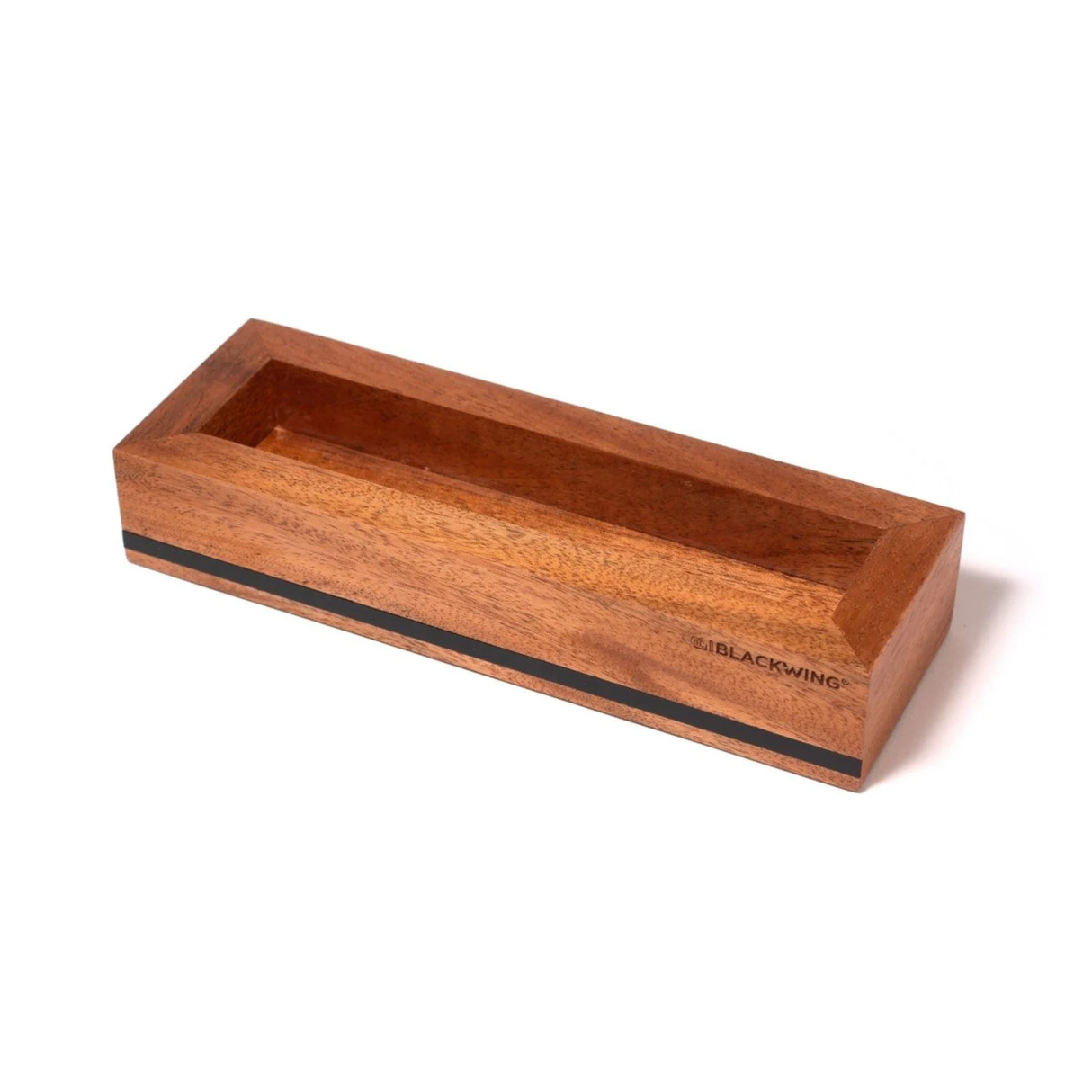 Put your favorite Blackwing 12-pack on display. This mahogany, solid wood pencil display is designed to showcase a single 12-pack Blackwing pencil box in a flat-lay position. Its clean, premium, and minimalist profile fits perfectly on every desk, shelf, or wall using the predrilled mounting holes. The Blackwing logo is engraved on the side.
The Blackwing Flat Box display measures 9.8125 x 3.25 x 1.75 inches.