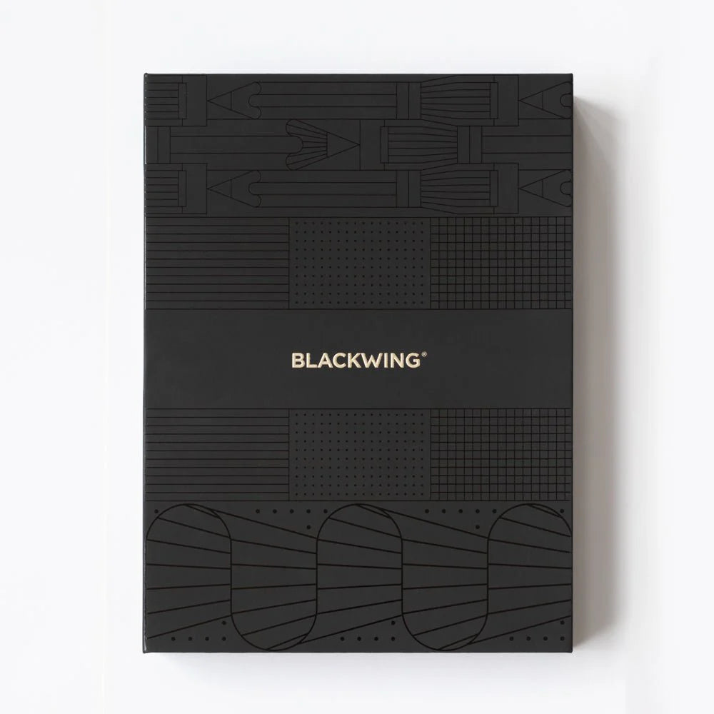 A great way to get started on the Blackwing journey. Give the gift of high-quality Blackwing pencils, paper & accessories — all in one box set.
Includes a Medium Black A5 Slate Notebook, each of our core pencils (602, Matte, Pearl, Natural), One-Step Long Point Sharpener, and Point Guard -- all packaged in a box set.