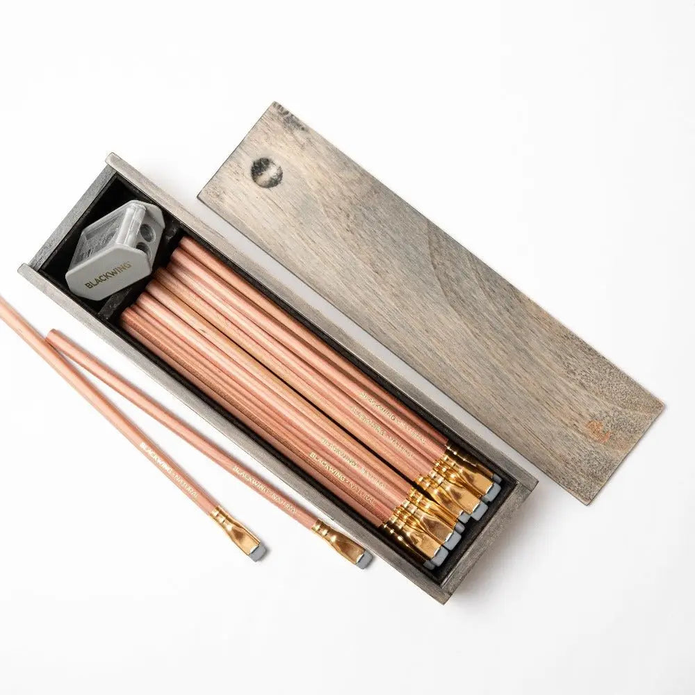 Blackwing Rustic Box Set - Natural
The Blackwing Rustic Box features your choice of 12 premium Blackwing graphite pencils and our reliable Two-Step Long Point Sharpener. Choose from 12 Matte pencils,12 602 pencils, 12 Pearl pencils, 12 Natural pencils, or 3 of each. The aged pine pencil box slides open to reveal the Blackwing pencils and a black cork-lined interior. The smooth stationery box is perfect for any workspace, office, or desk.
All Rustic Boxes now come with our Grey Two-Step Long Point Sharpene