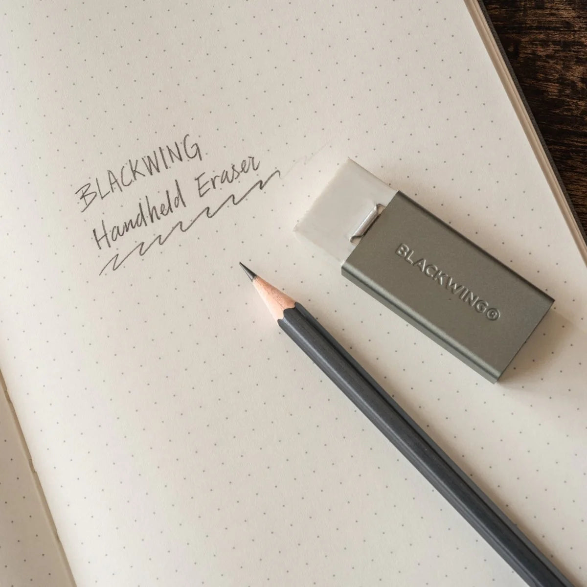 We took the iconic design of our eraser clip and adapted it into a sleek handheld form that feels great to use.
The eraser is made of a special soft material that erases the dark lines of our graphite cleanly and easily. The holder is made of durable aluminum that lets you get a solid grip while erasing. It also includes a jumbo-sized version of the iconic Blackwing clip, so you can extend the eraser as you use it.