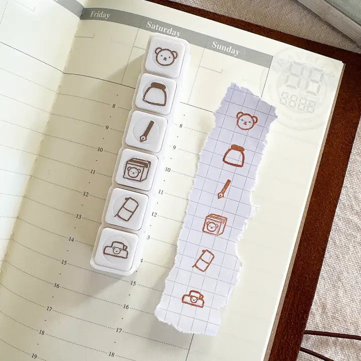 This button stamp captures Bear's favorite things!!
Fountain pens, inks, happy mail, planners, and clips!!
Our stamps add a sweet and cute touch to your planner or journal. Add them in your journaling, planning, and memory keeping spreads!
Stamped image is approximately 0.8cm wide.