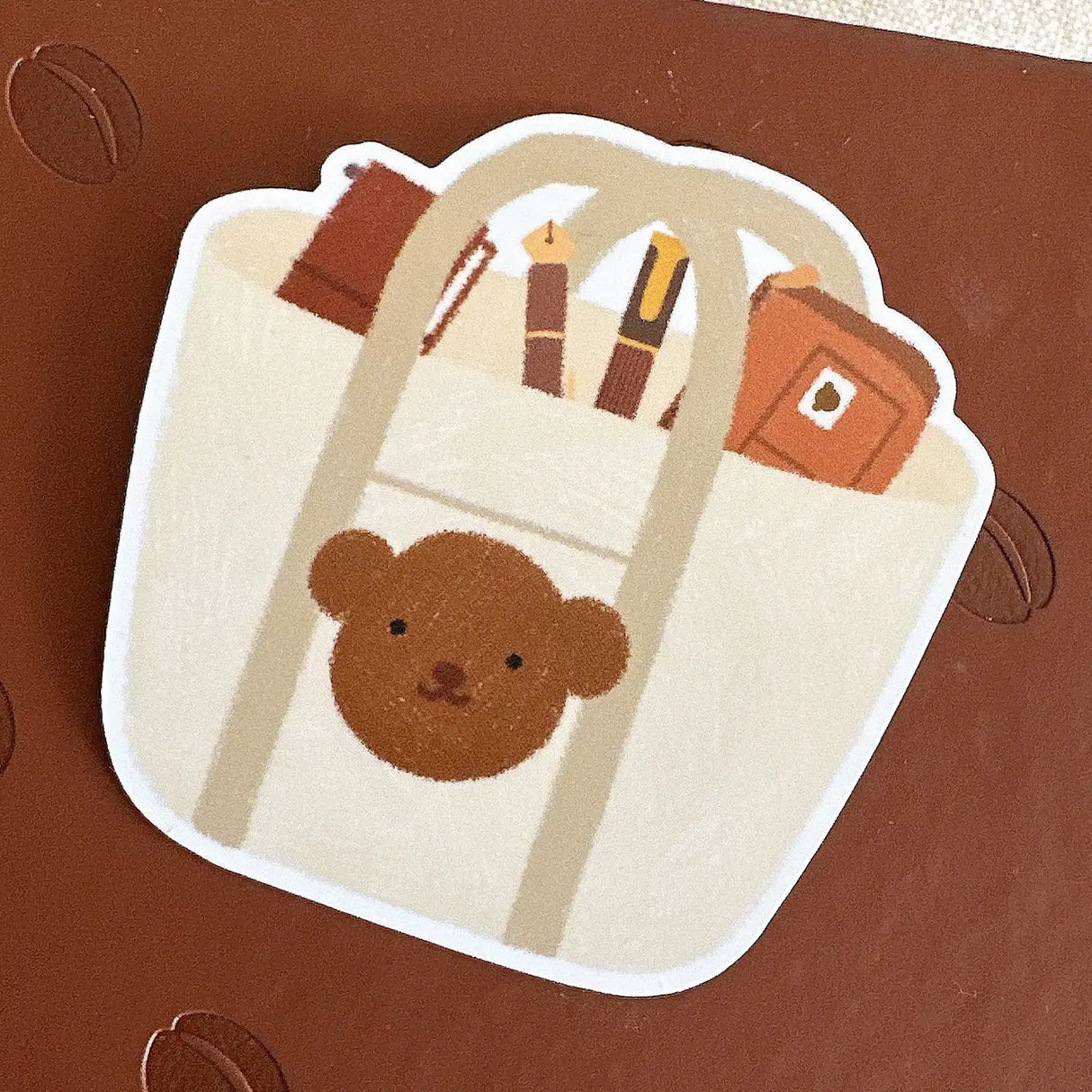 Bloom Paper Studio Die Cut Sticker - Choco's Planner Bag
Choco's tote bag contains his planner pouch, fountain pens, and traveler's notebook!
made with:
- premium matte sticker paper
- weatherproof
- 2.4"x2.4"
Note: Colors on screen may appear slightly different on paper. By purchasing, you have acknowledged reading this disclaimer.