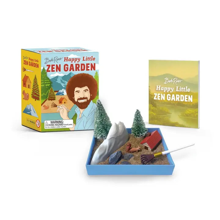 Looking for a mini mindful escape? Just as the Joy of Painting star inspires calm and relaxation with his art, this original Zen garden inspired by Bob Ross is certain to relieve everyday stress.
Everything you need for your Bob Ross Zen Garden: 3-5/8 x 2-3/4-inch mini Zen gardening tray, bag of sand, stones, “fan brush” rake, and mini accessories (Peapod the squirrel, snow-topped mountain, log cabin, 2 bristle-brush trees)
Illustrated mini book: Includes a 32-page 2-1