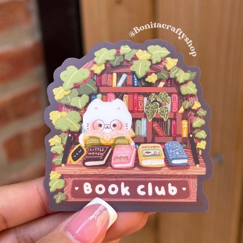Join the cutest book club around with this Book Club Cat Sticker! Surrounded by stacks of classic books, this cozy cat with glasses is the perfect reading buddy for bookworms and cat lovers alike. This kawaii library sticker captures a warm, cottagecore aesthetic with leafy vines, wooden shelves, and soft colors that make it feel like a mini reading nook. Ideal for adding charm to your laptop, water bottle, journal, Kindle, or planner.
♡ STICKER DETAILS ♡
~ Sticker size: 2.5’’ inches
~ Printed on matte sti