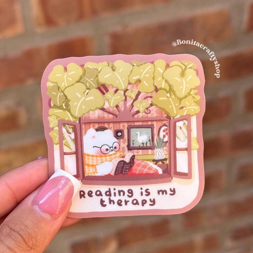This cozy matte vinyl sticker features an adorable cat curled up with a book and the warm quote “Reading is my therapy.” Perfect for bookworms, cozy lovers, and anyone who finds comfort in a good story.
♡ STICKER DETAILS ♡
~ Sticker size: 2.5’’ inches
~ Printed on matte sticker paper
~ Matte Laminate finish ✨
~ ONLY Handwash. This sticker is not dishwasher or microwave safe.