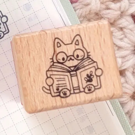 A small wood stamp of a little literary kitty for your planner and scrapbooking needs. Each stamp measures approximately 1 x 0.75 inch.
Stamps come loose and without any extra packaging.
