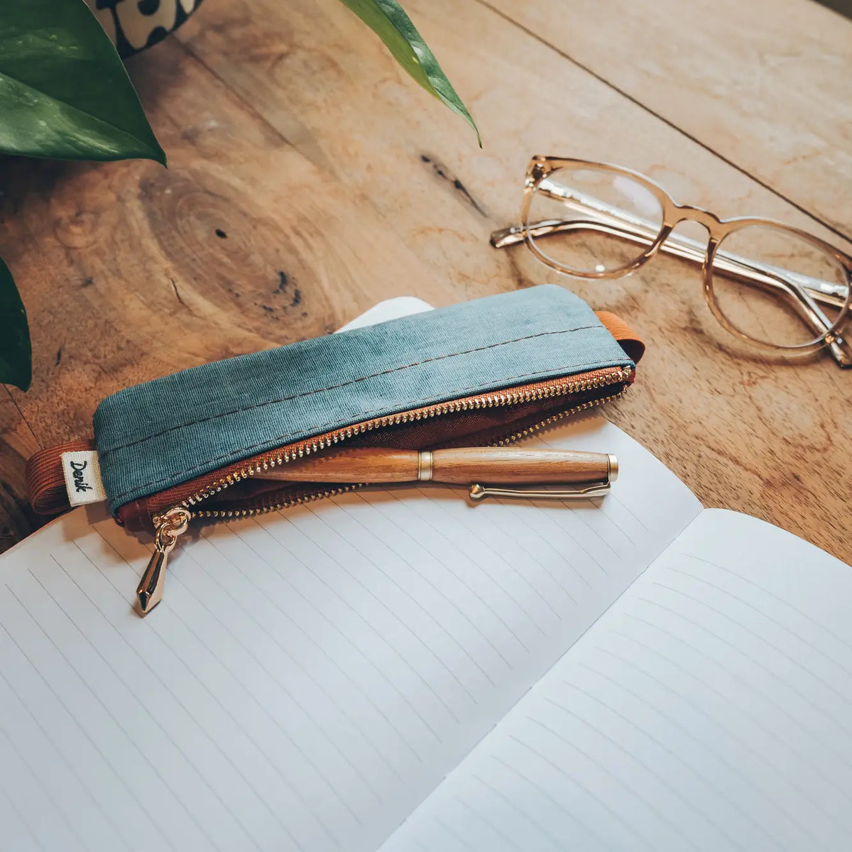 Denim Distressed Blue Notebook Pouch
Keep your go-to notebook and must-have pens together with our Denim Blue Notebook Pouch (honestly, we should’ve made these sooner). Designed with a fabric front, PU back, and a fully nylon-lined interior, it features an elastic band that fits snugly around most notebooks—so you’re ready for everyday ideas on the go.
Vegan Leather Pouch with Zipper
Elastic Fits Books up to 9" High
Zipper closure
9" x 3.75"