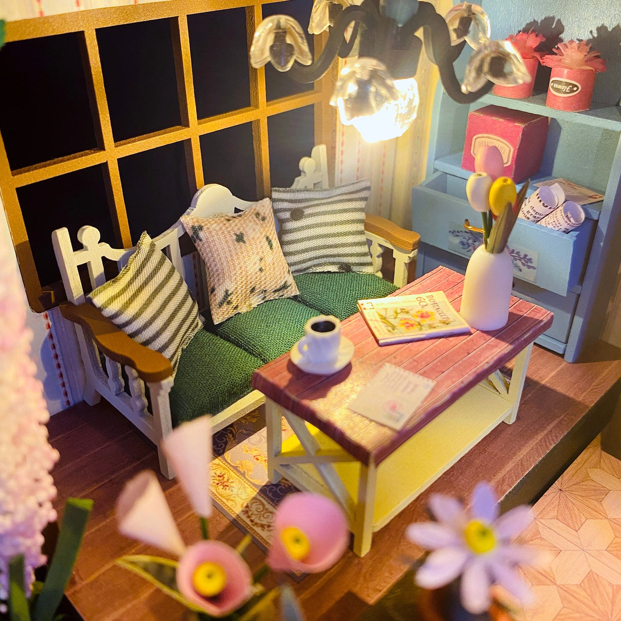 Escape into a peaceful retreat with this miniature kit-a dreamy blend of indoor charm and outdoor beauty. This cozy loft is a plant lover's paradise, filled with blooming flowers, lush greenery, and thoughtful touches of home. With a comfy sofa, a charming desk, and warm light that illuminates the space, it's the perfect hideaway for creativity and relaxation.
2 AAA batteries required; batteries are not included.
Age Range: 14+
Assembled Dimensions: 8.7 x 6.7 x 9.25 inches