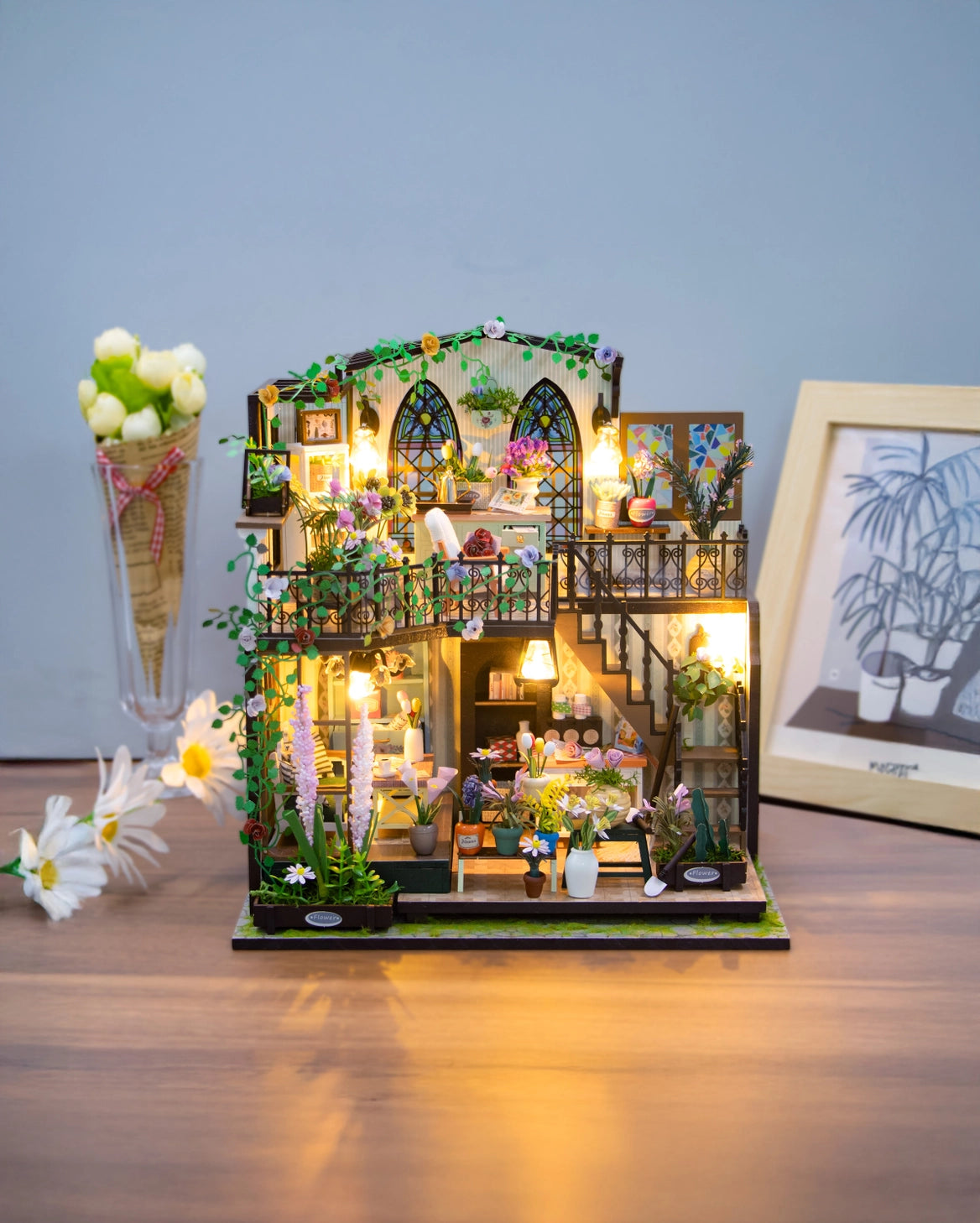 Escape into a peaceful retreat with this miniature kit-a dreamy blend of indoor charm and outdoor beauty. This cozy loft is a plant lover's paradise, filled with blooming flowers, lush greenery, and thoughtful touches of home. With a comfy sofa, a charming desk, and warm light that illuminates the space, it's the perfect hideaway for creativity and relaxation.
2 AAA batteries required; batteries are not included.
Age Range: 14+
Assembled Dimensions: 8.7 x 6.7 x 9.25 inches