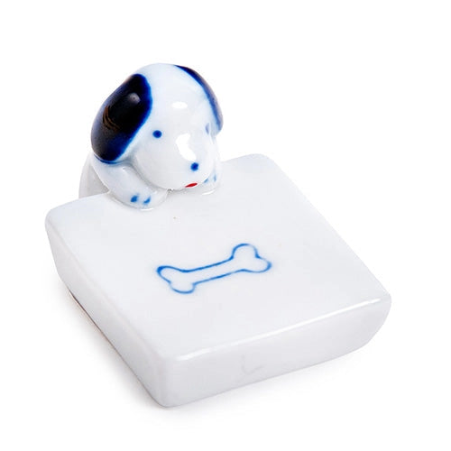 Porcelain dog and bone chopstick rest / pen rest.