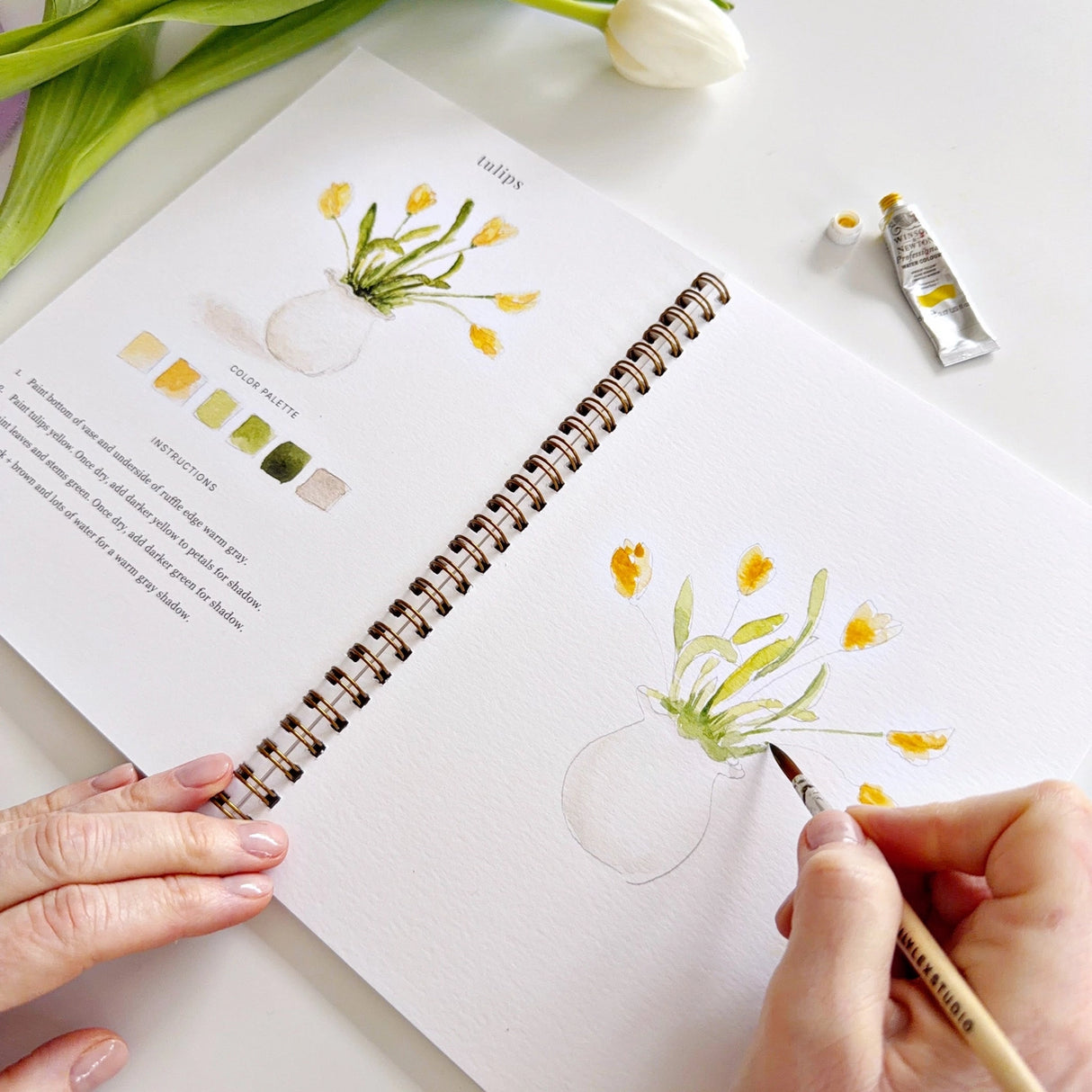 Twelve spring illustrations — a bunny, baby chick, tulips, lilacs, an Easter basket, a bicycle with flowers, and more — each pre-outlined with step-by-step instructions. Paintings take about thirty minutes from start to finish, making it approachable for first-time painters and a favorite for gifting.
Enjoy this peaceful painting hobby on your own, with children, or with friends. Makes a wonderful gift and is perfect for artists of any age.
Details:
12 beginner-friendly illustrations
Thick 120lb watercolo