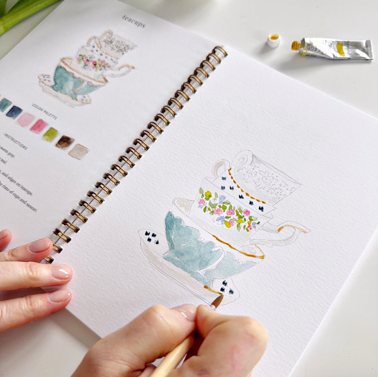 Twelve spring illustrations — a bunny, baby chick, tulips, lilacs, an Easter basket, a bicycle with flowers, and more — each pre-outlined with step-by-step instructions. Paintings take about thirty minutes from start to finish, making it approachable for first-time painters and a favorite for gifting.
Enjoy this peaceful painting hobby on your own, with children, or with friends. Makes a wonderful gift and is perfect for artists of any age.
Details:
12 beginner-friendly illustrations
Thick 120lb watercolo