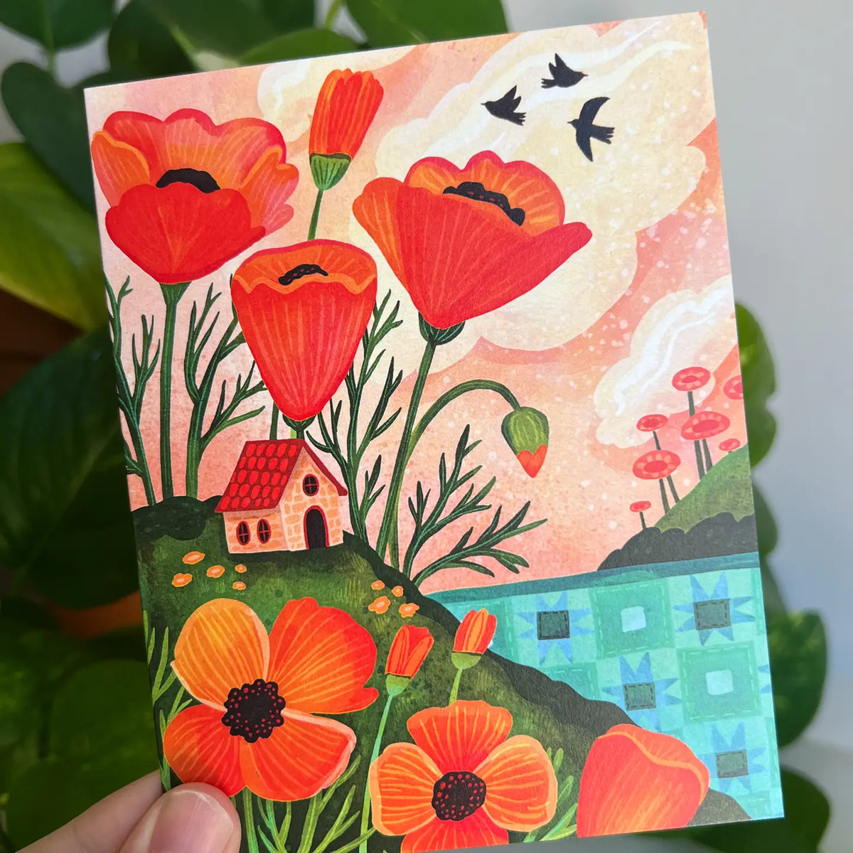 Emmylou Illustrations - Orange Poppy Cottage Greeting Card
Spring or Summer greeting card featuring colorful orange poppies, cozy cottage, and a quilted lake/ocean. Perfect for anniversaries, birthdays, Mother’s Day, housewarming, or just because! All greeting cards are hand illustrated by me!
Printed on premium heavyweight matte cardstock, this A2 card is blank inside—ready for your handwritten notes.
Includes a kraft envelope