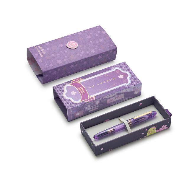 Esterbrook x Sakuradragon Sakura Street Estie Fountain Pen
Created with artist Cindy Duong of Sakuradragon, the Sakura Street Estie brings her imaginative illustrated world to Esterbrook's traditional Estie fountain pen. Its U.S.-blended material combines translucent purple with colorful glitter sparkle, while the custom clip is etched with Cindy's Sakura pattern. Dual Esterbrook and Sakuradragon engraving and a gold-plated converter finish the design. Each pen arrives in special packaging with Japanese gi