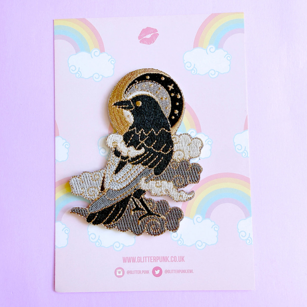 This fabulous patch features a black crow surrounded by grey glittery clouds, and a starry moon with grey backgrounds.
Beautifully woven with black, white, grey & gold threads, this fabulous patch with brighten up any coat, bag or hat!
Measurements: 70mm x 90mm