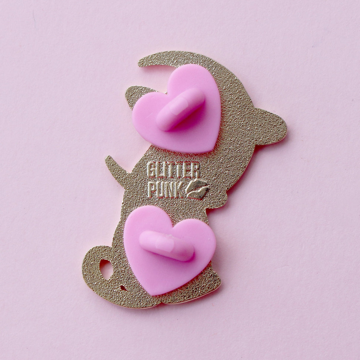 Cute, cuddly and clever – there’s no cat quite like a Sphynx! This fab enamel pin features a black Sphynx covered in mystical symbols, sitting in front of a crescent moon with 2 purple clouds.
The pin is 42mm (1.65”) tall, and is made from gunmetal hard enamel, with glitter and UV printed details. It's secured with 2 pink clutches to keep the pin in place.