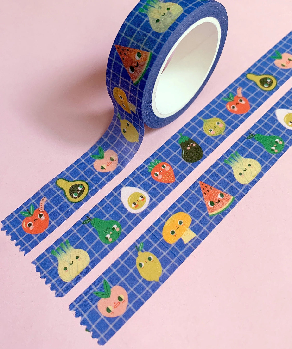 'Kitchen Club' washi tape roll, 15mm H x 10m L, in a recyclable card box.
Cute collection of fruit and veggie pals on a wobbly-check blue background.