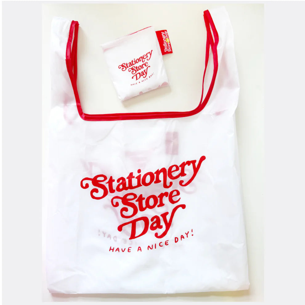 Stationery Store Day 2026
Polyester foldable tote with art by Karen Schipper
Bag is 14.25" W x 3.25" D x 22.5" H with a 6.7" handle drop.
Folds into pouch appx 4.25".
Red trim and cute SSD tag!