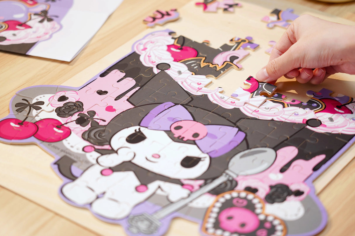 Discover joy with the Hello Kitty Wooden Jigsaw Puzzle: Kuromi Cherries and Cookies (88pcs). This officially licensed Sanrio product features iconic Hello Kitty in 96 vibrant wooden pieces. Crafted for durability and a seamless fit, it's a delightful challenge for fans of all ages 8+. Embrace positivity and bring Hello Kitty to life with this charming puzzle – perfect for relaxation and family fun. Display your completed masterpiece proudly and celebrate the timeless appeal of Hello Kitty.