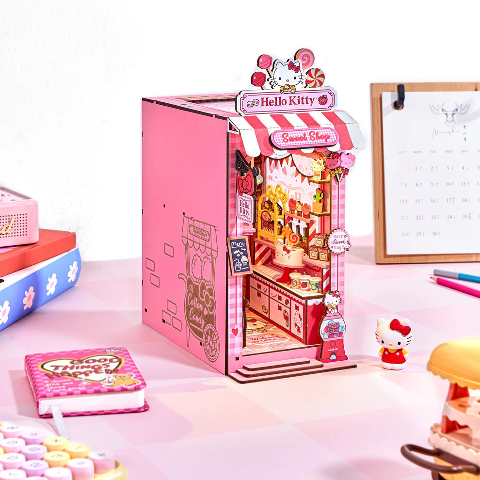 Step into a sugary dream with this irresistibly charming book nook kit, featuring Hello Kitty herself in a candy shop that's overflowing with sweetness and delight! From candy jars lining the shelves to pastel goodies peeking out from every corner, this magical miniature world is bursting with adorable, mouthwatering details.
And the showstopper? A dazzling lollipop chandelier that hangs like a crown jewel above the shop, casting a whimsical glow over the entire scene. It's a heart-melting centerpiece that