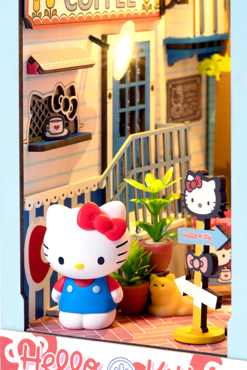 Step into the delightful world of Hello Kitty Town Square with this charming DIY miniature book nook! This beautifully crafted scene features a cozy alleyway filled with inviting cafes, lush plants, and charming little shops, capturing the peaceful vibe of a lively town square. At the heart of the alley, Hello Kitty stands happily, adding a sense of joy and warmth to the entire scene.