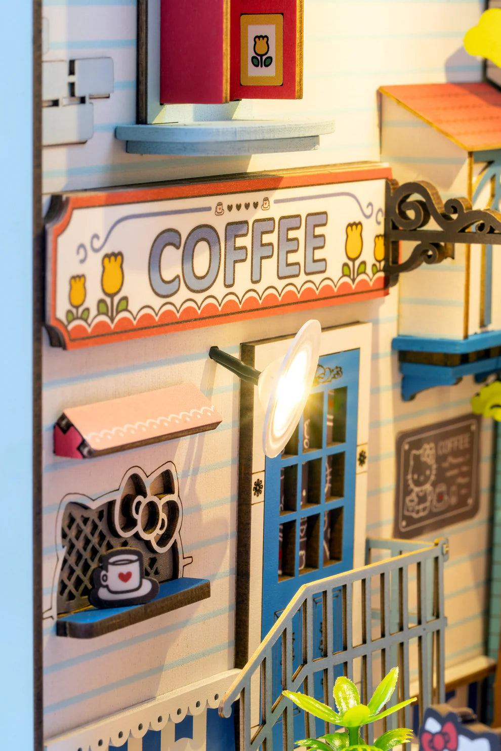 Step into the delightful world of Hello Kitty Town Square with this charming DIY miniature book nook! This beautifully crafted scene features a cozy alleyway filled with inviting cafes, lush plants, and charming little shops, capturing the peaceful vibe of a lively town square. At the heart of the alley, Hello Kitty stands happily, adding a sense of joy and warmth to the entire scene.