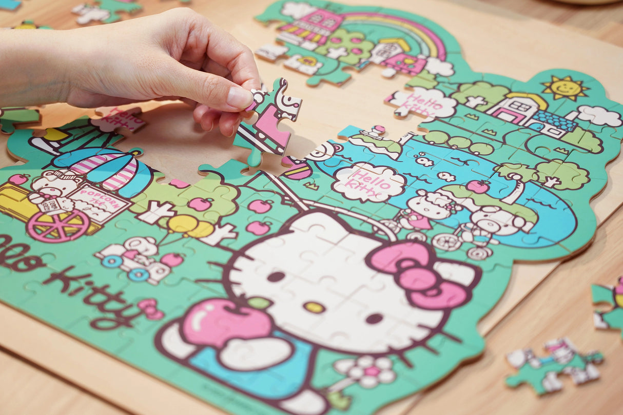 Discover joy with the Hello Kitty Wooden Jigsaw Puzzle: Amusement Park (96pcs). This officially licensed Sanrio product features iconic Hello Kitty in 96 vibrant wooden pieces. Crafted for durability and a seamless fit, it's a delightful challenge for fans of all ages 8+. Embrace positivity and bring Hello Kitty to life with this charming puzzle – perfect for relaxation and family fun. Display your completed masterpiece proudly and celebrate the timeless appeal of Hello Kitty.