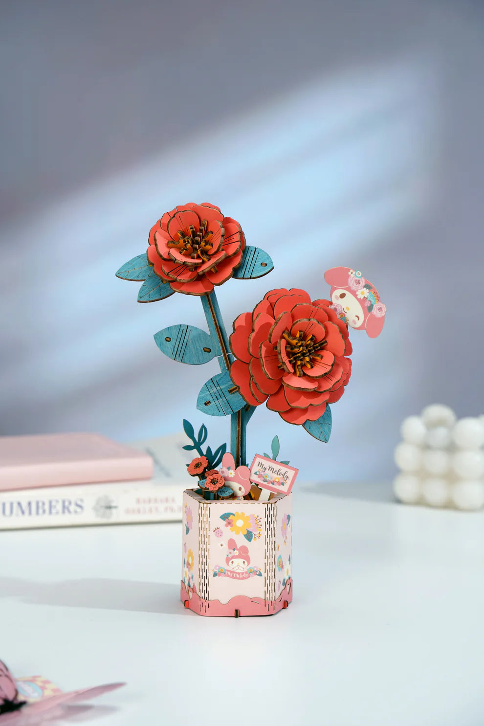 This 3D Wooden Puzzle Kit from Hands Craft lets your creativity bloom as you build a beautiful red camellia flower featuring the beloved My Melody character from Hello Kitty and Friends. Made from high-quality natural wood, the pieces fit together precisely, offering a fun and rewarding challenge for both adults and kids.