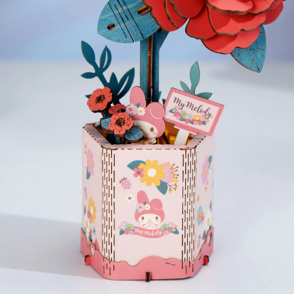 This 3D Wooden Puzzle Kit from Hands Craft lets your creativity bloom as you build a beautiful red camellia flower featuring the beloved My Melody character from Hello Kitty and Friends. Made from high-quality natural wood, the pieces fit together precisely, offering a fun and rewarding challenge for both adults and kids.