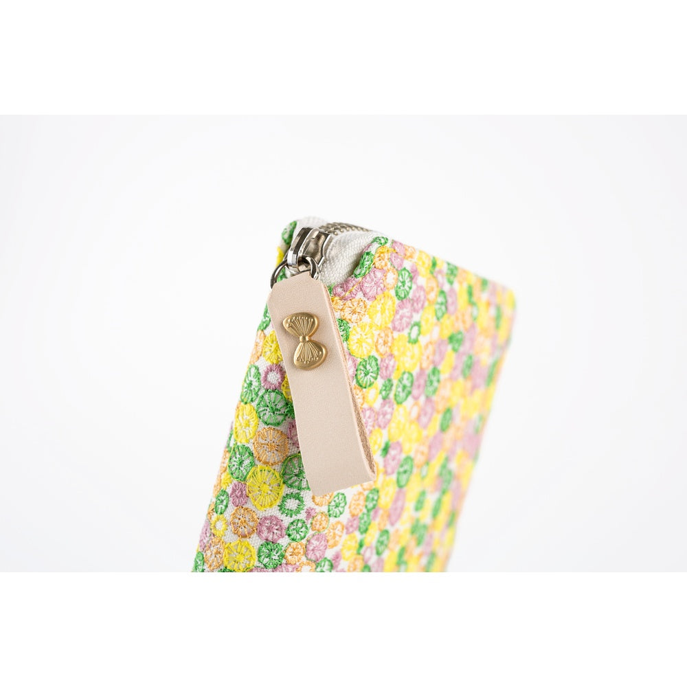 The zipper pull is made out of a natural leather, and the butterfly-shaped fastening adds a cute charm.