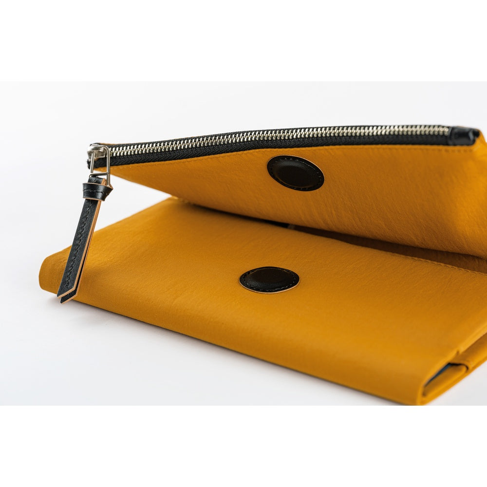 The cover closes with a hidden magnet, which is padded with a leather patch for a softer touch. The outer pocket also features a leather zipper pull.