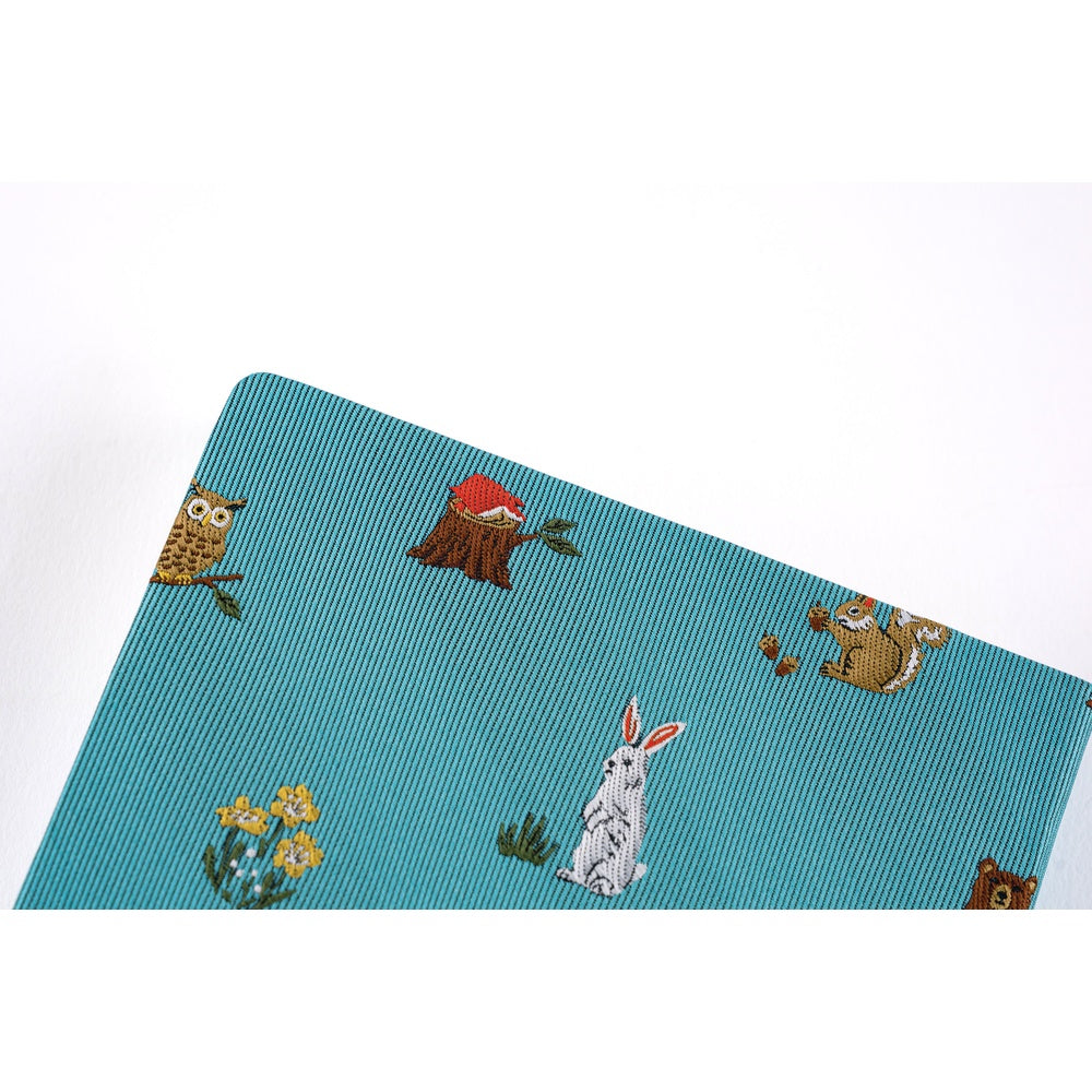 Somewhere in the design, you’ll find a Hobonichi Techo resting on a tree stump. It feels as if someone has paused to take a break in the forest, surrounded by the animals.