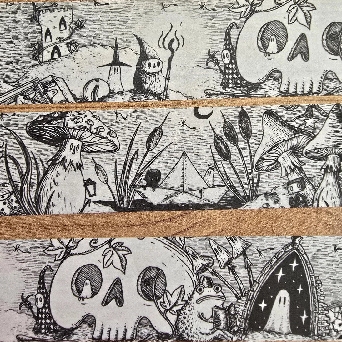 A unique and infinitely repeating fantasy landscape of melancholy oddities and curious characters, from original hand-drawn ink artwork by Jon Turner, recreated with incredible detail at miniature size in this washi tape that invites you to find new tiny details with every viewing.
This is a special extra-wide washi tape, 30mm high which really brings out all the tiny details. perfect for creating a decorative border when journalling, or for packing parcels with surreal style. 10m long.