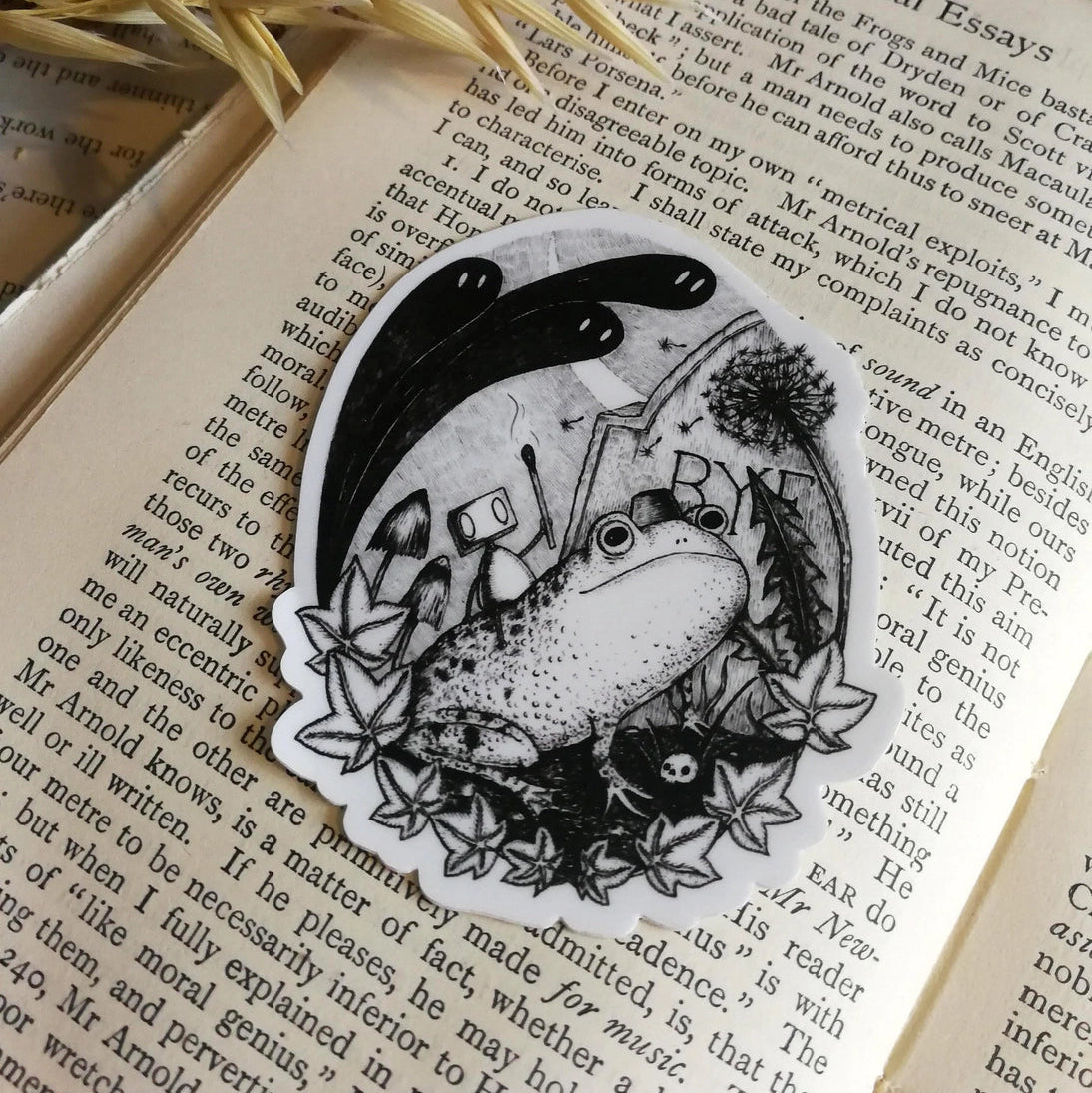 Sticker featuring a little robot and his faithful frog companion making their way through the haunted graveyard, from original pen and ink artwork by Jon Turner.