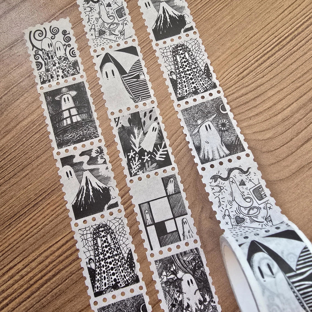 One of two tapes from the Creative Spirits series by Jon Turner, little ghosties taking you on an eclectic tour of art history. This roll features ghosts inspired by Vincent Van Gogh, Frida Kahlo, Piet Mondrian, Claude Monet, Henri Matisse, Hokusai, Malika Favre, Gustav Klimt, Keith Haring, and Yayoi Kusama.
Perforated to look like a roll of postage stamps, this washi tape features a repeating pattern of ten designs in portrait format from hand-drawn pen and ink artwork, recreated in incredible detail at m