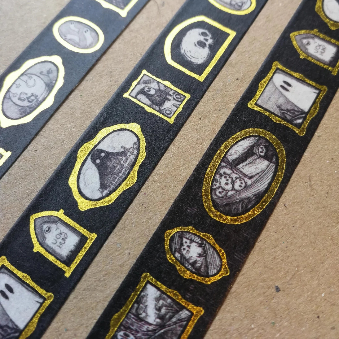 Turn every surface into a tiny gallery with this washi tape featuring tiny Jon Turner artworks in shiny gold frames, an array of little robots, ghosts and other spooky oddities. Perfect for spooky journalling or curious correspondence.
Two designs available, with each tape featuring 16 miniature masterpieces in a repeating pattern. Each roll measures approximately 15mm wide, and the roll is 10m long; they are cello wrapped and decorated with branded stickers on either side.
15mm wide
10m length