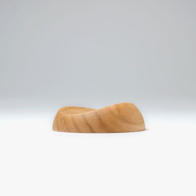 A pen rest that enhances the moments between writing. Designed to hold any pen without the need for precise placement, it blends effortlessly into your desk space with a subtle but assured presence. Enjoy the rich texture and wood grain of Japanese cherry.
Designed for stability to ensure your pens and surfaces are protected from accidental movement or damage. The pen rest comfortably holds two to three slender pens.
Use and Care:
To prevent distortion and discolouration, avoid soaking in water, sudden t
