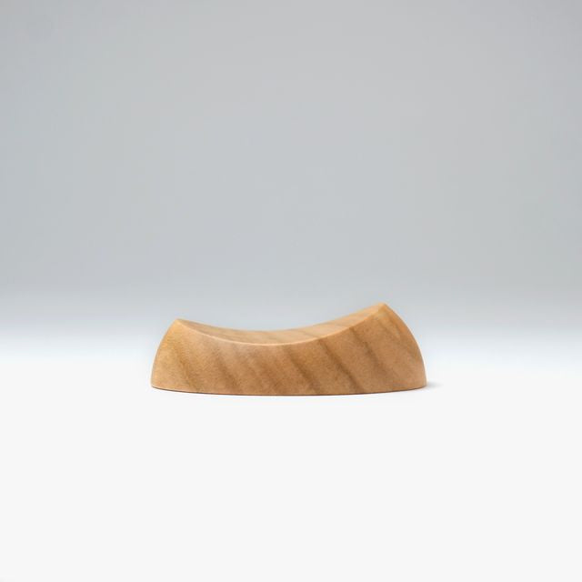 A pen rest that enhances the moments between writing. Designed to hold any pen without the need for precise placement, it blends effortlessly into your desk space with a subtle but assured presence. Enjoy the rich texture and wood grain of Japanese cherry.
Designed for stability to ensure your pens and surfaces are protected from accidental movement or damage. The pen rest comfortably holds two to three slender pens.
Use and Care:
To prevent distortion and discolouration, avoid soaking in water, sudden t